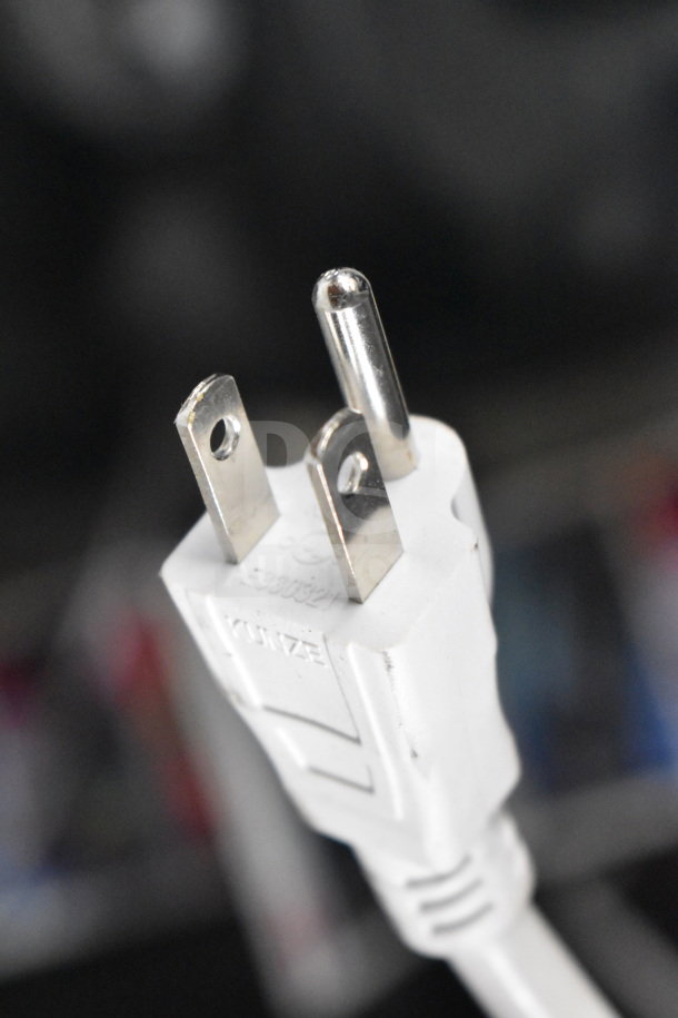 Close-up of a white power plug labeled "Kuntze" attached to an electrical cable, part of a store display.