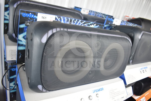 Onn large party speakers on display, featuring Bluetooth, 12-hour playtime, and 160 watts. Auction includes four speakers.