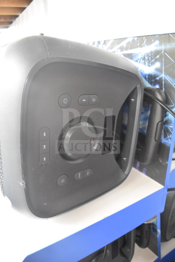 Onn large party speaker on store display, featuring control buttons and knob. Likely in good condition.