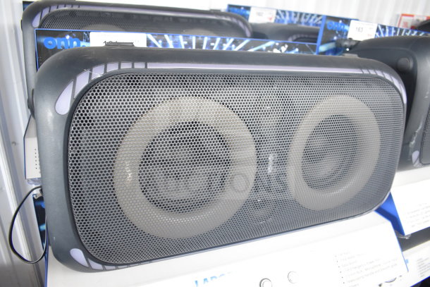 Onn large party speaker on a store display, featuring dual large drivers and a black mesh grille, in good condition.