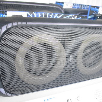 Onn large party speaker on a store display, featuring dual large drivers and a black mesh grille, in good condition.
