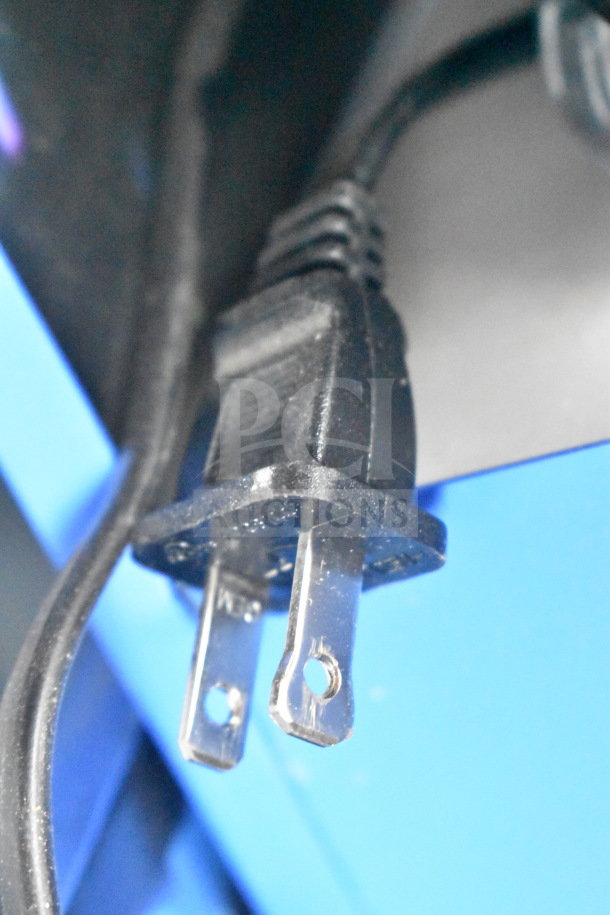 Close-up of a power plug from an Onn large party speaker, showing prongs and black cord. Auction item component detail.