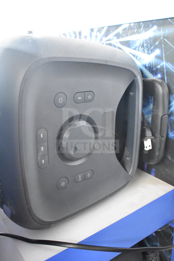 Onn large party speaker display, featuring control buttons and dials. Includes power cord. Ideal for events and gatherings.