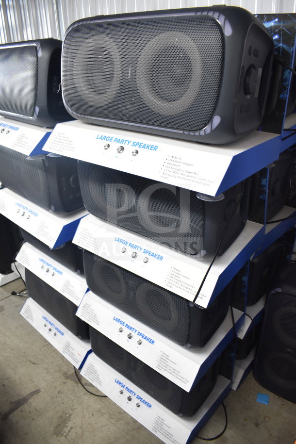 Onn Large Party Speaker store display, featuring multiple units. Labeled details include FM radio, bass boost, water-resistant design.