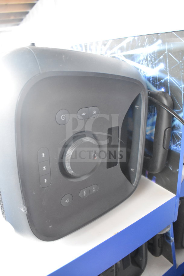 Onn large party speaker, black, with control panel featuring power, playback, and light buttons. Good condition, store display.