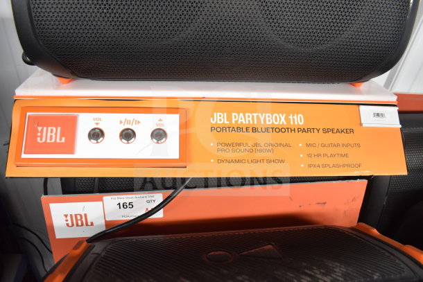 JBL Partybox 110 speaker display. Features 160W sound, dynamic light show, mic/guitar inputs, 12hr playtime, IPX4 splashproof.