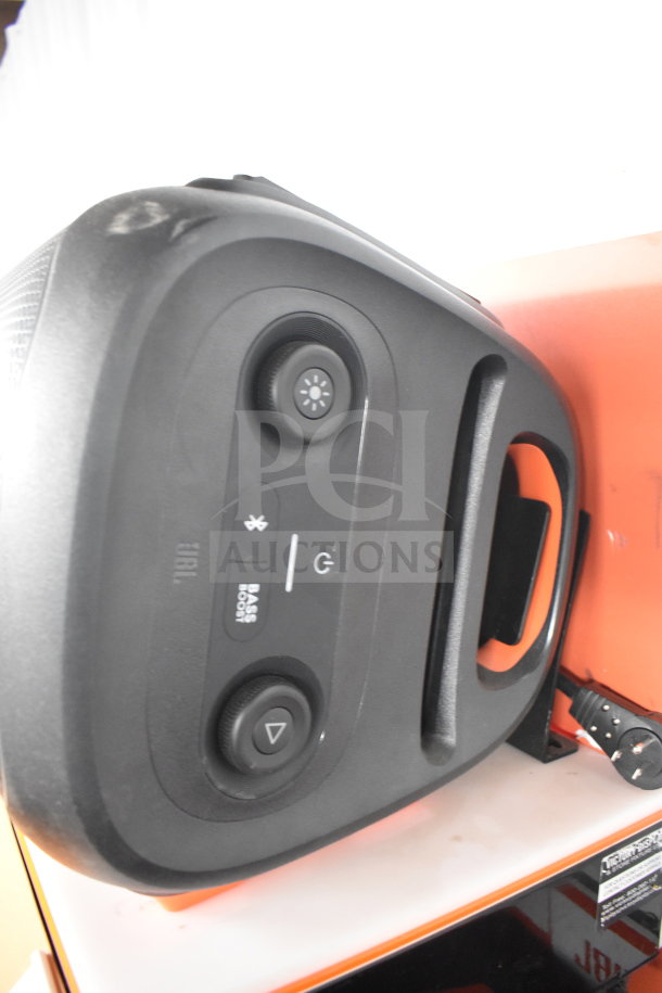 JBL Partybox 110 Speaker in store display. Features include Bluetooth, bass boost, and lighting control. Good condition.