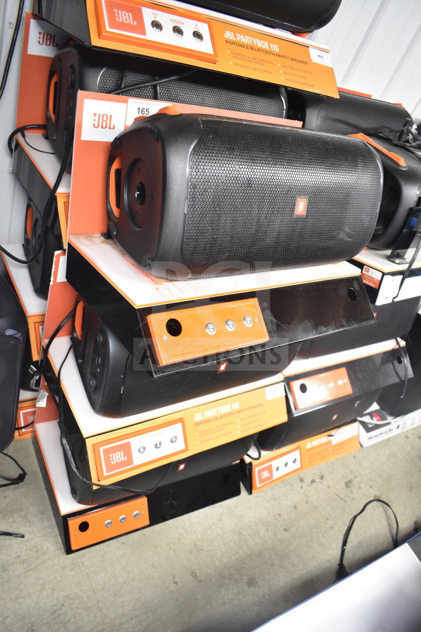 JBL Partybox 110 speaker store display, showing multiple units in new condition with original packaging and branding.