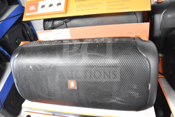 JBL Partybox 110 speaker on display with orange tag, features listed, showing slight wear, excellent for dynamic sound.