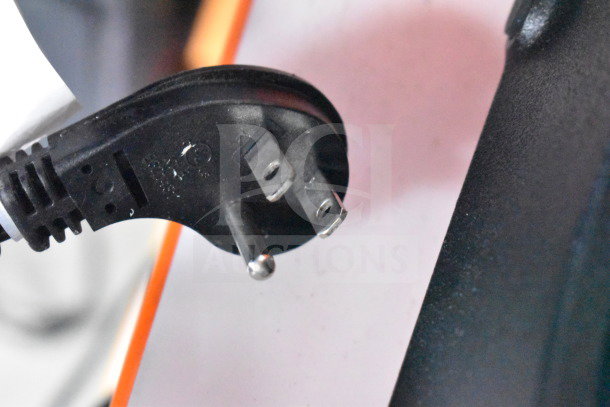 Close-up of a power cord plug from a JBL Partybox 110 speaker, showing two flat prongs and one round prong, in good condition.