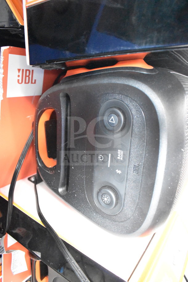JBL Partybox 110 speaker on store display, featuring bass boost and Bluetooth controls. Includes power cable.