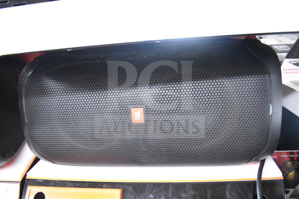 JBL Partybox 110 speaker in excellent condition, features black grille with JBL logo. Part of a 6-store display auction.