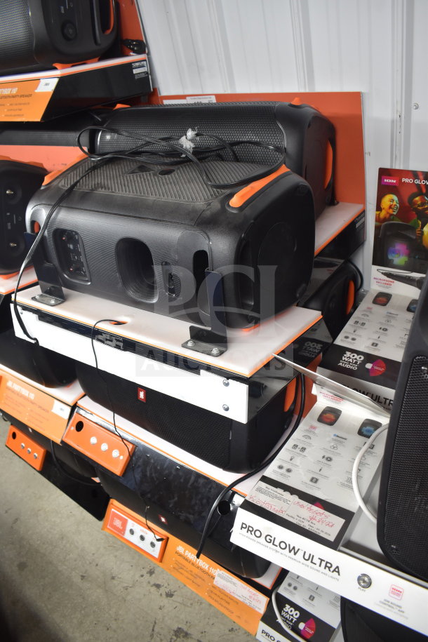 6 JBL Partybox 110 speakers on display; excellent condition, vibrant sound quality, promotional packaging visible.