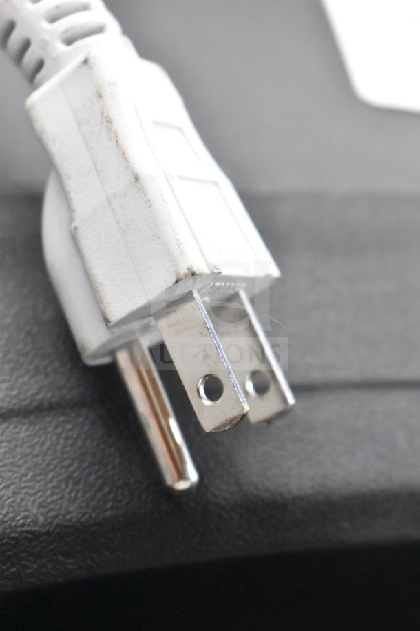 Power plug for Ion Pro Glow Ultra Speaker store display. White, slightly worn condition, close-up view.