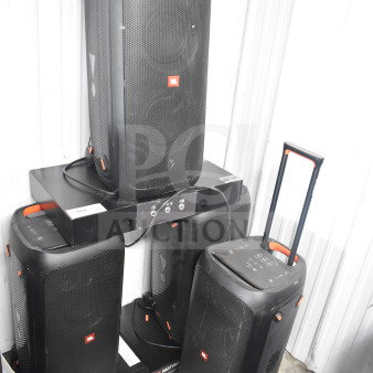 Four JBL Partybox 310 speakers with visible controls and handles, used condition, offering powerful audio output.