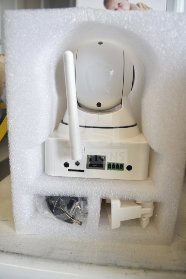 Wi-Fi video surveillance camera in original packaging, showing ports and accessories, including antenna and mounting hardware.