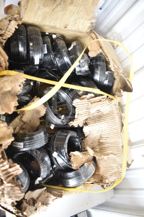 Box of 10m cables in original packaging, multiple coiled black cables, visible labels, and damaged box exterior.