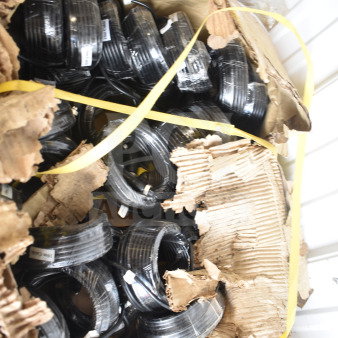 Box of 10m cables in original packaging, multiple coiled black cables, visible labels, and damaged box exterior.