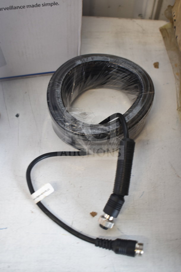Box of 10m cables in original packaging, black, coiled, with labeled connectors, appearing unused.