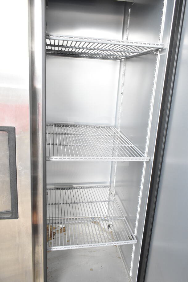2024 True T-35-HC commercial 2-door reach-in cooler with shelves, on casters, 115 volts, 1 phase. Slight interior wear.