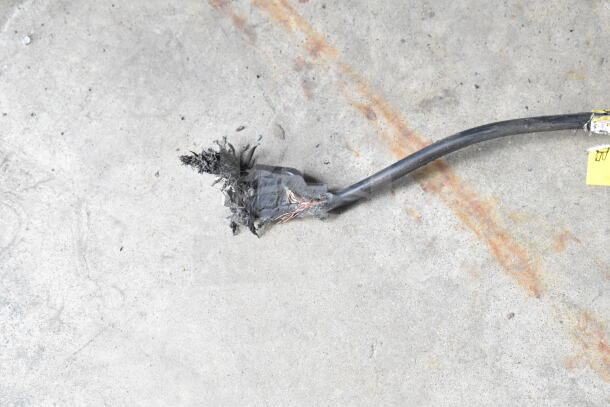 Severely damaged power cord from a 2019 IDW G4-H0234B mini cooler merchandiser, showing exposed wires. 115 volts, 1 phase.
