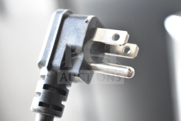 Close-up of a power plug from the Arctic King ARV115B1AST Mini Cooler Merchandiser, showing a standard 3-prong connection.