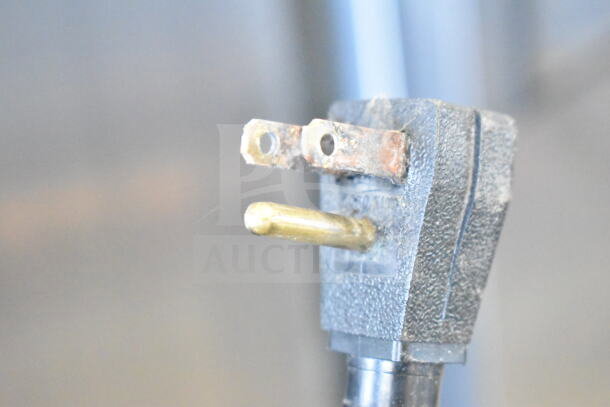 A close-up of a power plug for a True T-19F commercial freezer, showing wear and signs of use.