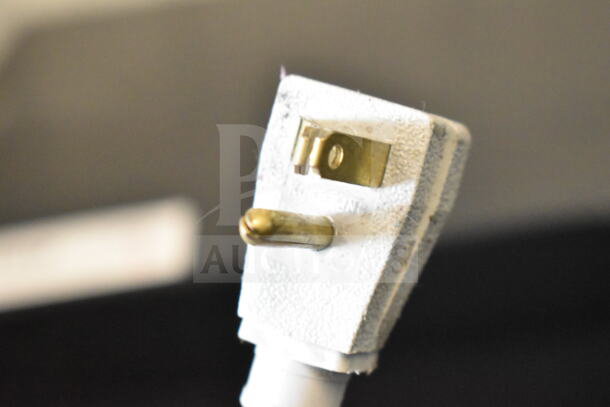 Close-up of a three-prong plug attached to the 2018 True GDM-41SL-48-HC-LD commercial cooler, 115 Volts, 1 Phase.
