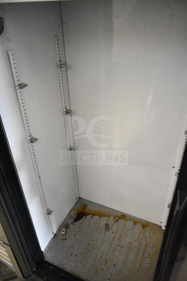 True GDM-41SL-60-LD cooler interior, showing empty space with shelving brackets and visible surface stains, used condition.
