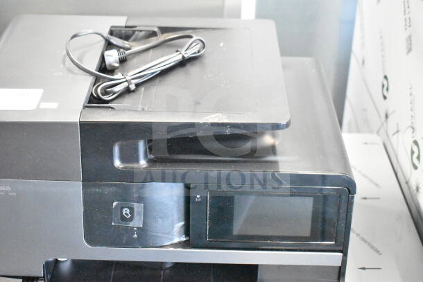HP OfficeJet Pro 8625 printer, copier, scanner, fax machine on a countertop. Includes power cord. Appears in fair condition.