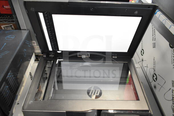 HP OfficeJet Pro 8625 multifunction machine, open scanner lid, HP logo, good condition, for printing, copying, scanning, faxing.