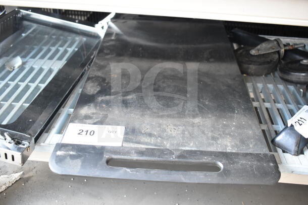 Nostalgia countertop electric griddle, 115 volts, 1 phase, black surface, used condition, auction lot tag 210 visible.