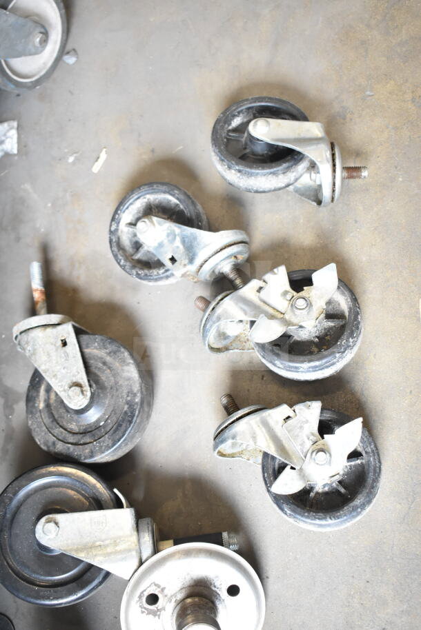 10 commercial casters and a metal table base piece, used condition. Auction lot offers 10 times your bid value.