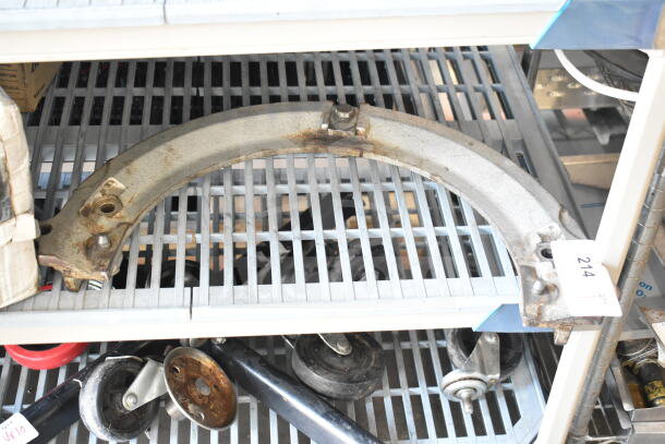 Commercial mixing bowl adapter, metal, used condition, slight rust, resting on metal shelving, auction tag visible.