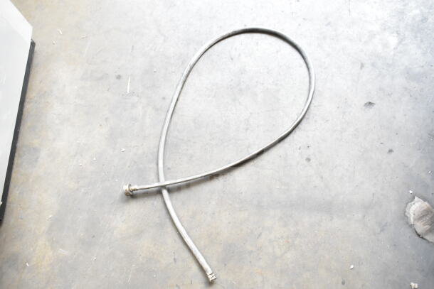 Flexible vacuum hose attachment in used condition, metallic finish, with connectors on both ends; part of a 3-item auction lot.