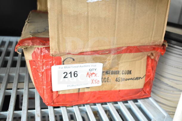 Box of 50 sharpened stainless steel chef knives, labeled "QTY APX 50," offered at auction by PCI Auctions.