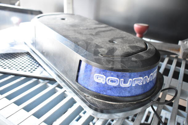 Dusty black and blue "GOURME" slushie machine hopper lid, part of an auction lot with various items.