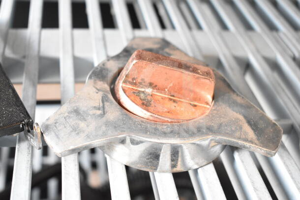 Industrial metal hopper lid with copper top, part of auction lot including espresso grinder hopper and slushie lid.