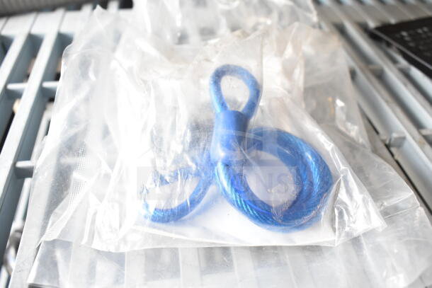 Clear bag with blue coiled cable, part of a lot including espresso grinder hopper and more. Multiple-use auction items.