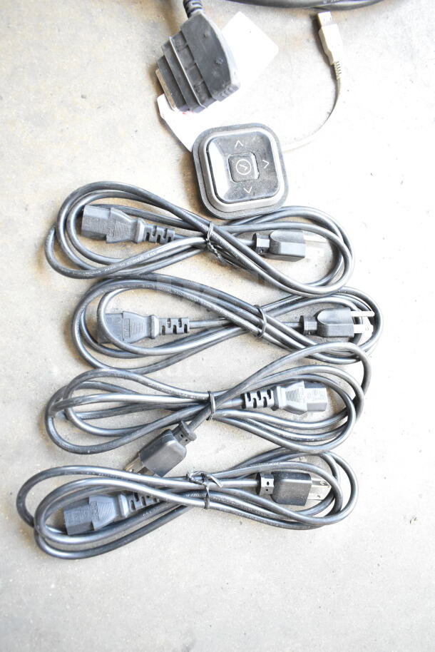 A set of six black electrical cords with plugs, bundled together. Includes a small black control panel with buttons.