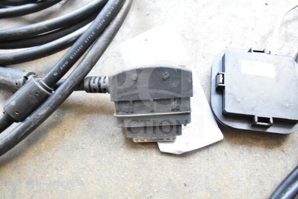 Various black cords and connectors in used condition. Visible marking on cord: "AWM E101344 STYLE 20276 VW-1 80°C".