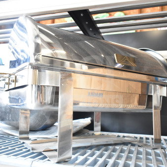 Stainless steel countertop roll top chafer with polished finish, visible sturdy legs, and a sleek lid design.