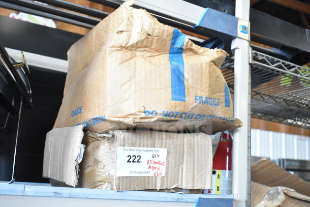 A damaged cardboard box labeled "FRAGILE," with auction lot sticker showing quantity and description of contents.