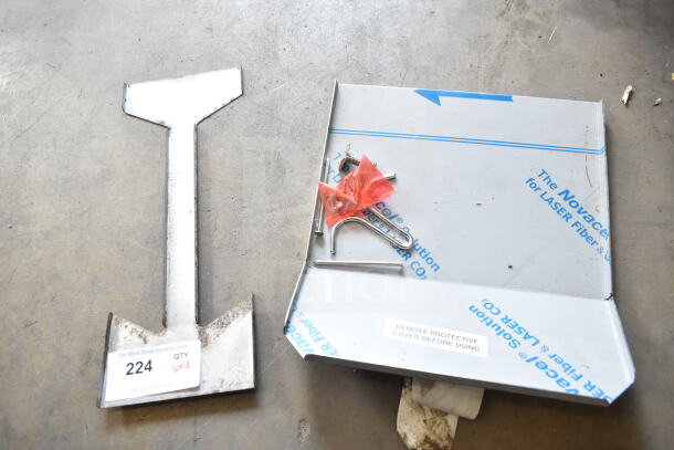 Various metal items including grease trap parts and mounting hardware. Includes a protective cover. Lot marked as 9x quantity.
