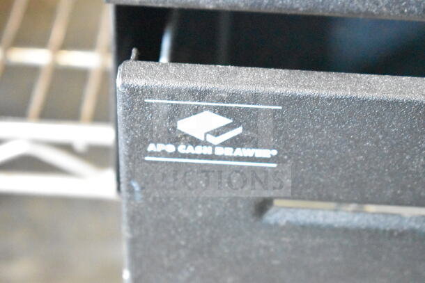 Black countertop cash drawer with visible "APG Cash Drawer" logo. Features durable construction and compact design.