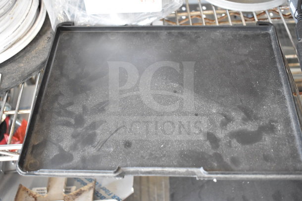 Black tray with fingerprints on metal shelf. Part of auction lot including brew basket and legs. Varying condition.