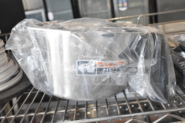 Metal brew basket wrapped in plastic with "Warning Hot Liquid" label, stored on a wire shelf. Part of a 3-item auction.