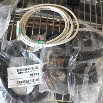 Four various cables, including Ethernet and USB, in plastic bags with labels indicating part numbers.