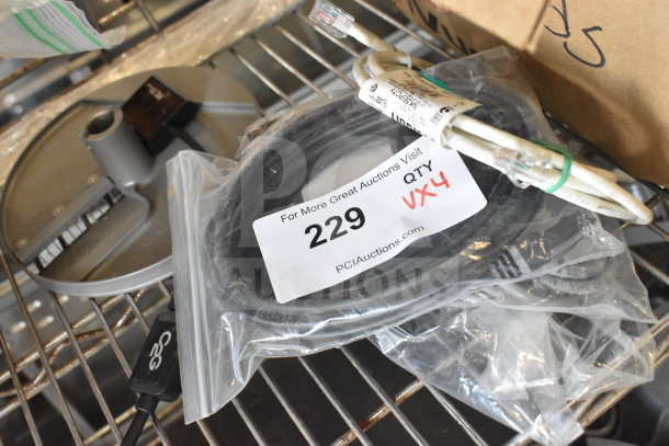 Four assorted items including cables on a metal shelf, labeled with auction tag "229, Qty 4." Items in plastic packaging.