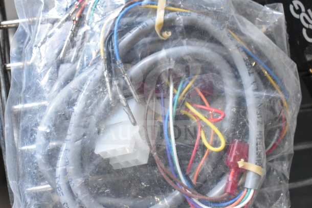 Bag of various cables, colorful wires, connectors, and plugs. Items bundled and sealed in plastic packaging.